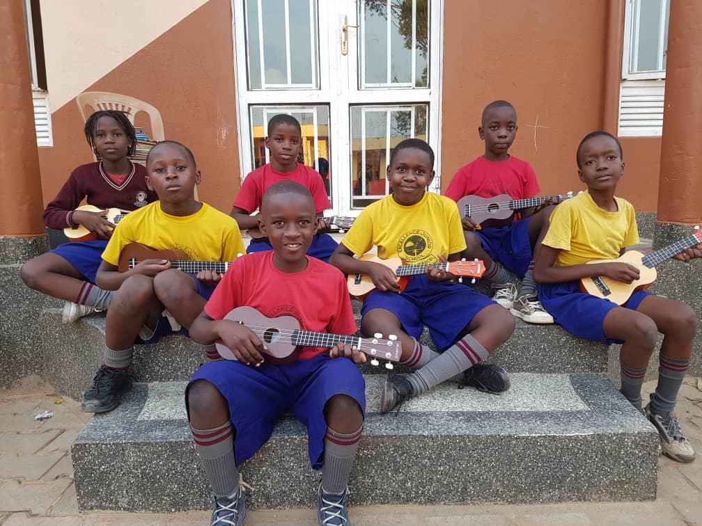 The first group of GCF students in Uganda learning ukulele together during the launch of our pilot program